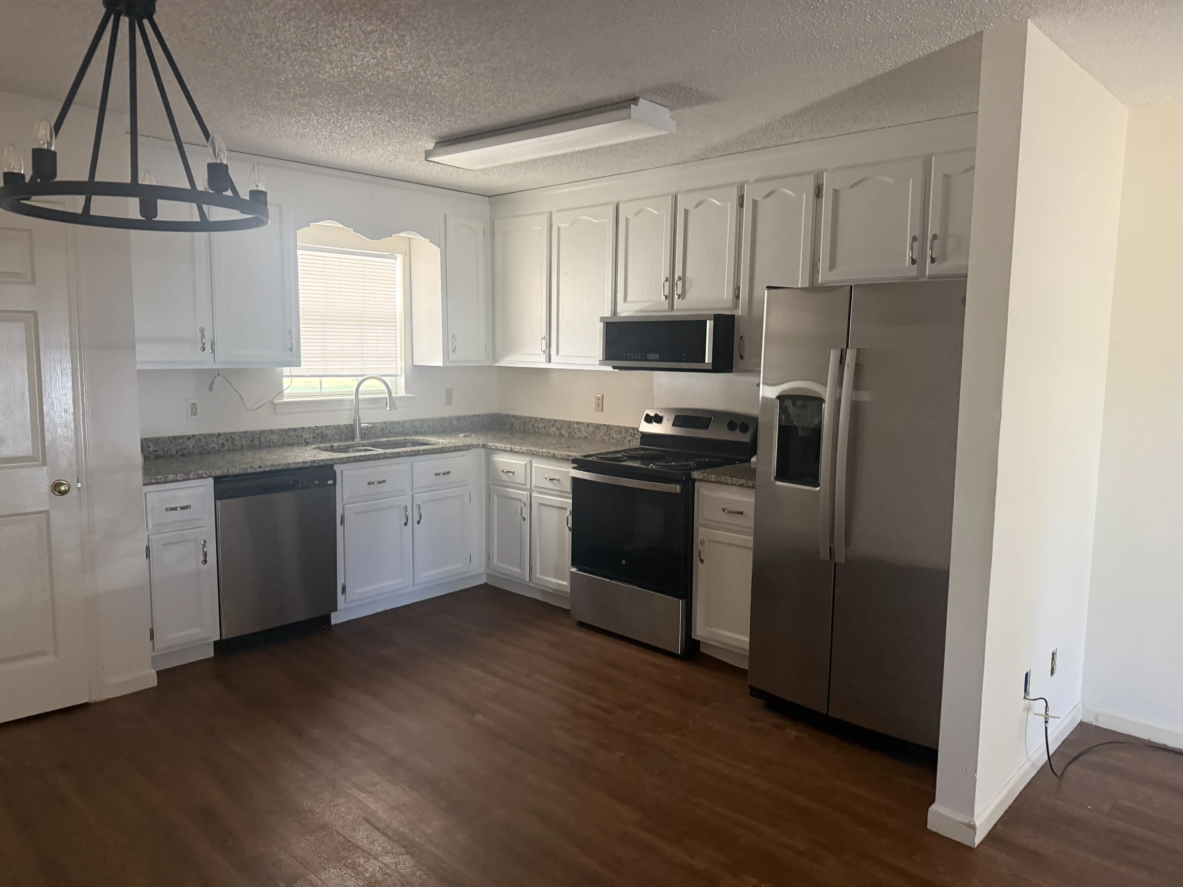 Renovated New Horizon kitchen with white cabinetry and stainless appliances