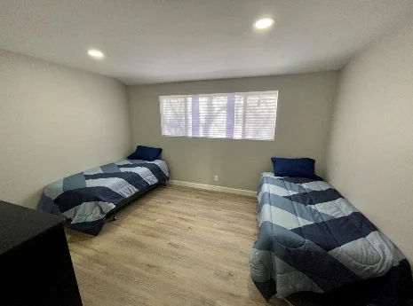 Shared bedroom furnished with two twin beds